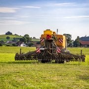 An agricultural vehicle spraying a field.