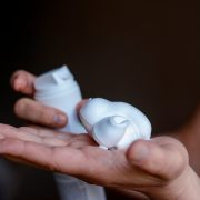 A picture of shaving foam on a persons hand.